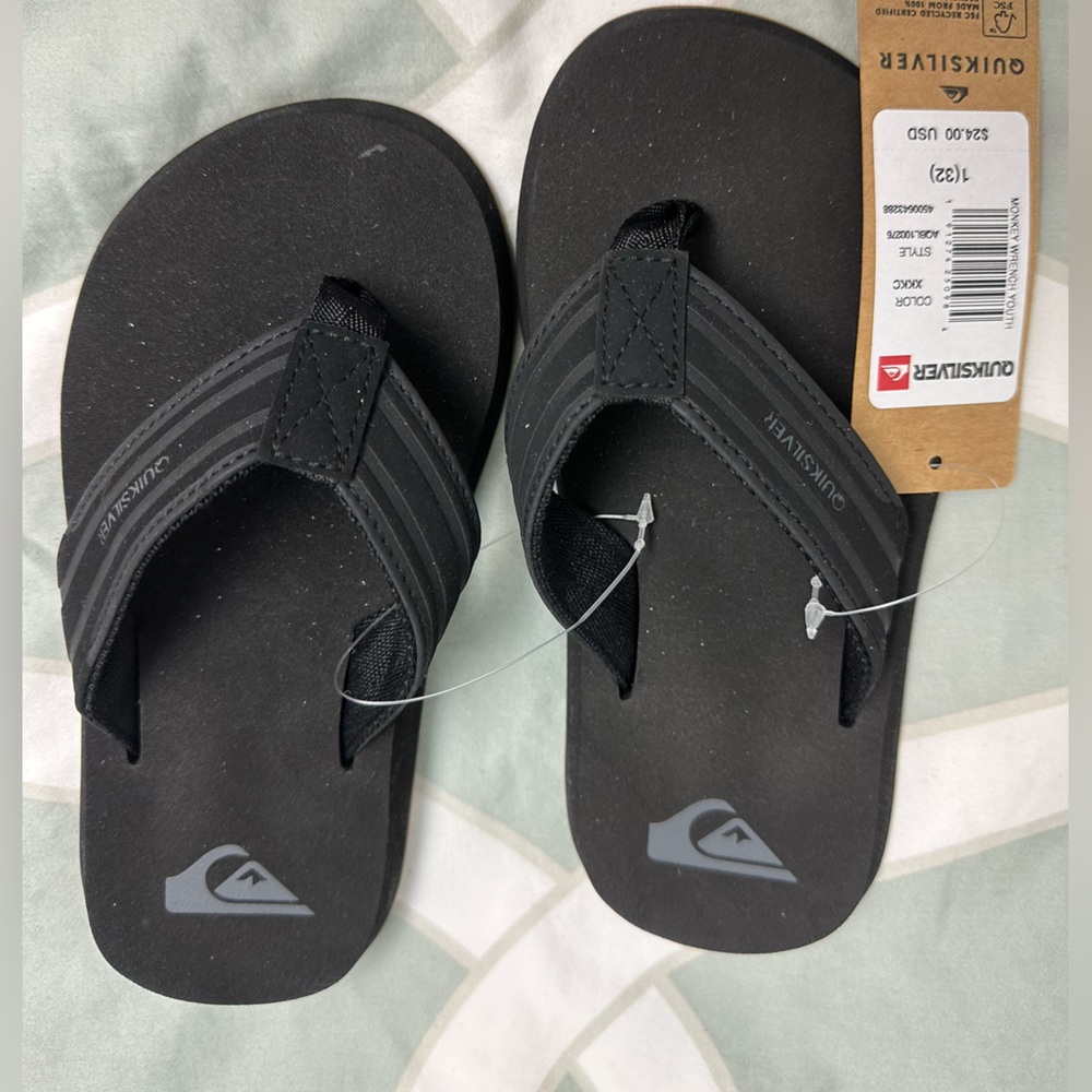 Quicksilver black flip flops. New with tags.